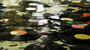 Broken records on the floor of a warehouse